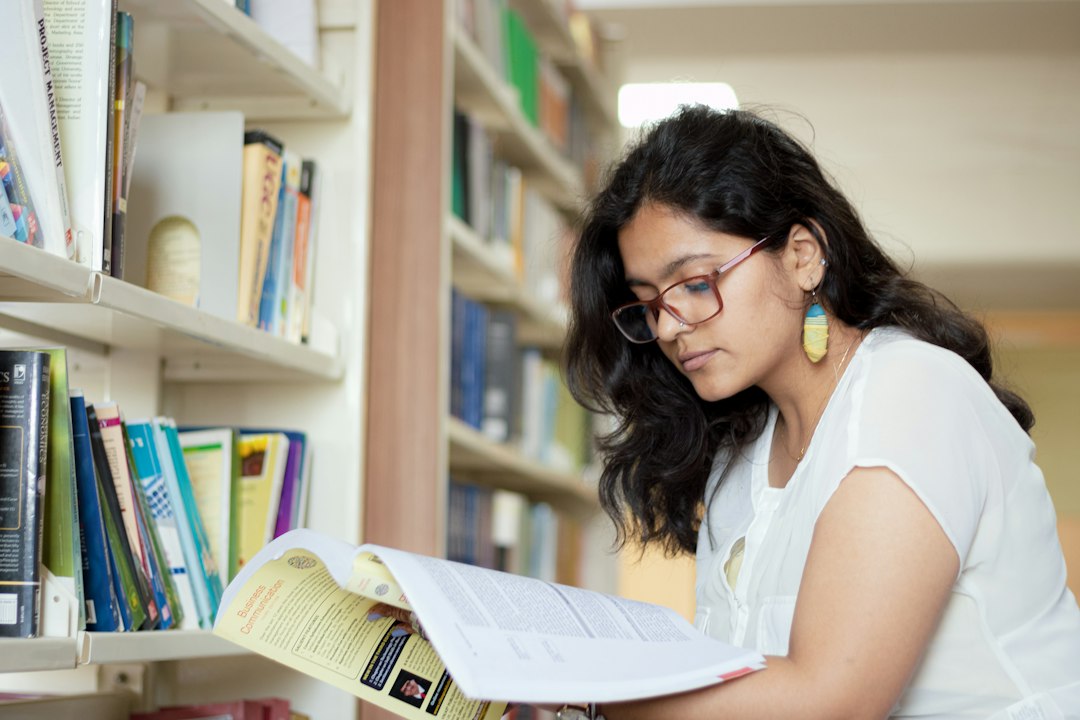 a woman reading a book in a library