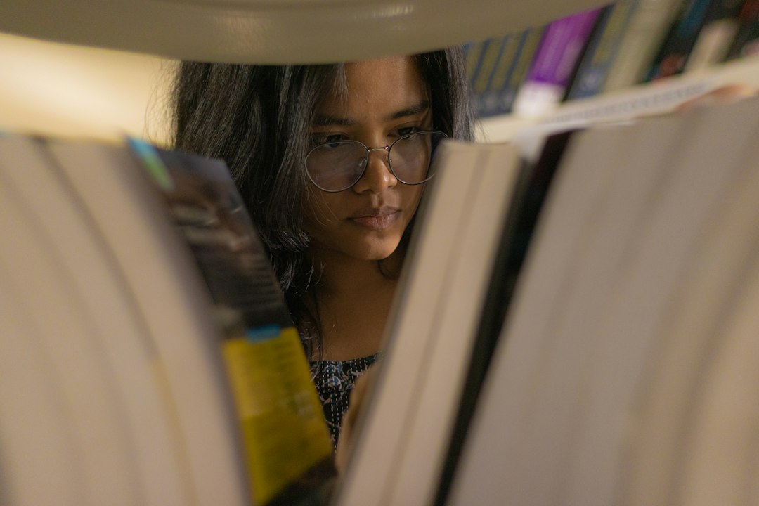 a woman reading a book in a library